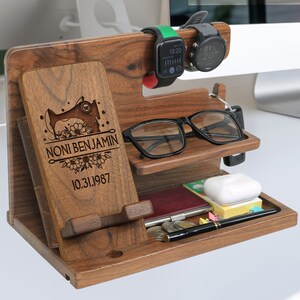May include: A wooden organizer with a phone stand, watch holders, a glasses holder, and a small tray. The organizer is personalized with the text "NONI BENJAMIN 10.31.1987" and a sewing machine design.