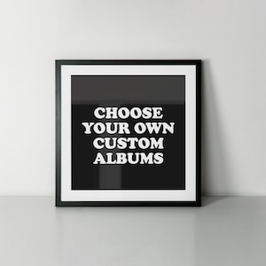 May include: Black and white framed print with the text "CHOOSE YOUR OWN CUSTOM ALBUMS" in a retro font.