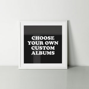 May include: White framed print with a black background and white text that reads "Choose your own custom albums".