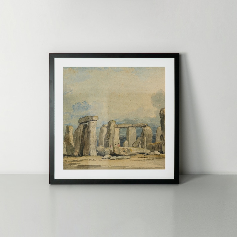 May include: A framed watercolour painting depicting Stonehenge, a prehistoric monument in England. The painting shows the iconic stone circle in a muted colour palette, with a cloudy sky in the background.