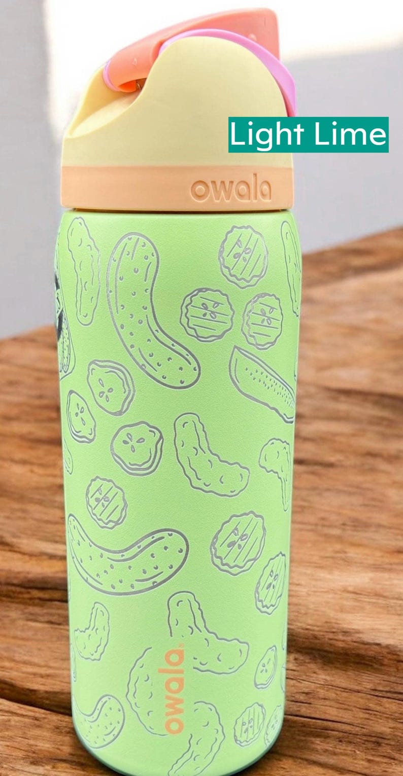 A green and yellow children's water bottle with a light lime design printed on it, sitting on a wooden surface.