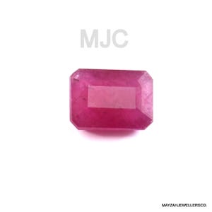 May include: A rectangular, faceted pink gemstone with a vibrant, saturated hue. The stone features a clear, polished surface with sharp edges and a distinct step-cut design. The text MJC is visible above the stone, and MAYZAHJEWELLERSCO. is at the bottom.