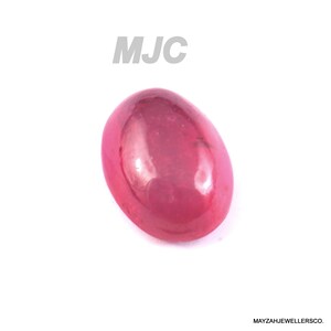 May include: A polished, oval-shaped, ruby-red gemstone. The gem is smooth and reflective, with a glossy surface. The letters "MJC" are printed in grey above the gemstone. The words "MAYZAHJEWELLERSCO." are printed in black below the gemstone.