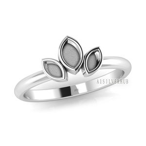 May include: A silver ring with three leaf-shaped designs. The ring is marked with "925" on the band.