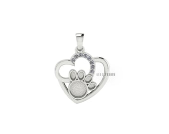 May include: A silver pendant in the shape of a heart with a paw print design. The pendant has a bail at the top for a chain and a small section of clear stones. The paw print is in the center of the heart.