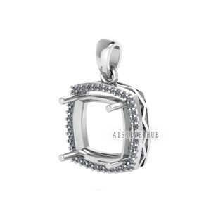 May include: A silver pendant with a square-shaped setting for a gemstone. The setting is surrounded by a row of small, clear stones. The pendant has a bail for attaching to a chain.