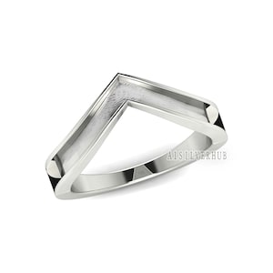 May include: A silver ring with a V-shaped design. The ring is polished and has a smooth finish. The text "A1SILVERHUB" is visible on the ring.