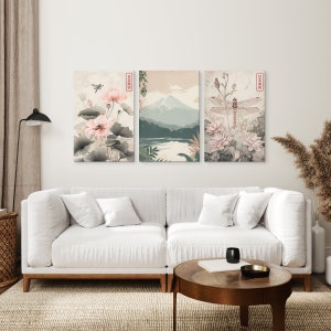 May include: Three framed prints with a Japanese theme. The left print features pink flowers and a dragonfly. The middle print shows a mountain range with a lake in the foreground. The right print features a dragonfly with pink flowers.