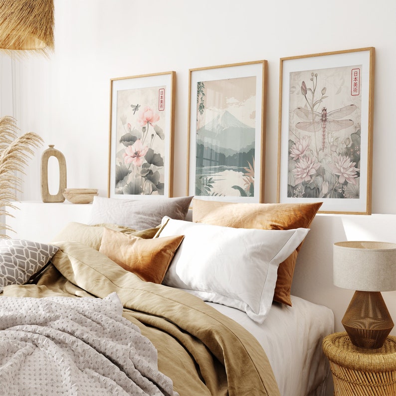 May include: A bedroom with a bed featuring a brown duvet and white pillows. Three framed prints hang on the wall above the bed. The prints feature Japanese-inspired artwork with flowers, a dragonfly, and a mountain landscape. The prints have Japanese text in the corner.