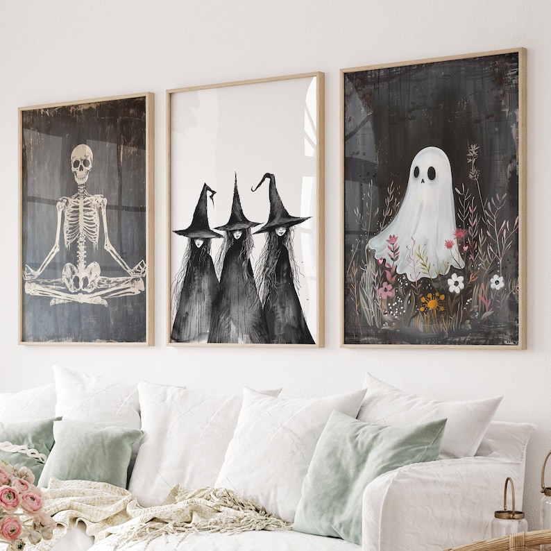 May include: Three black and white illustrations in frames. The first shows a skeleton sitting in a yoga pose. The second shows three witches with pointed hats. The third shows a white ghost in a field of flowers.