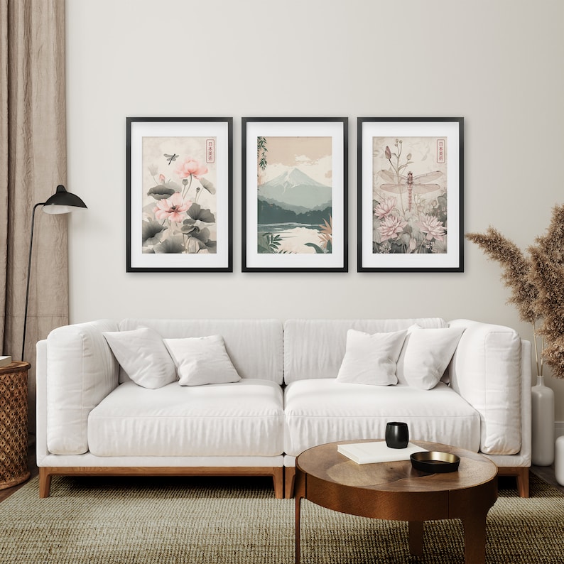 May include: Three framed prints with a Japanese theme. The left print features a pink flower with a dragonfly. The center print shows a mountain range with a lake in the foreground. The right print features a dragonfly with pink flowers.
