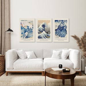 May include: Three framed Japanese woodblock prints, featuring the Great Wave off Kanagawa by Katsushika Hokusai, and two prints by Utagawa Kuniyoshi, titled "An Evening View of Fuji" and "Ojiya with Bamboo".