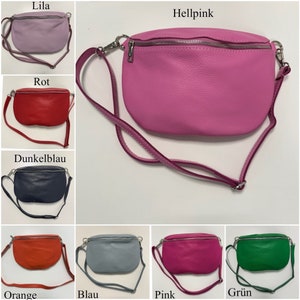 May include: Ten different coloured leather fanny packs with adjustable straps. The colours are lilac, hot pink, red, dark blue, orange, grey, pink, green, and black.