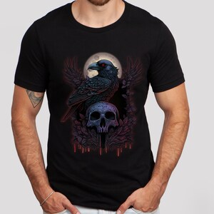 May include: Black t-shirt with a graphic of a raven perched on a skull with a full moon in the background. The raven has red eyes and the skull has a detailed design.