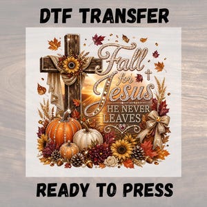 Puede incluir: Una transferencia DTF con una cruz de madera adornada con un girasol, tela drapeada y el texto Fall for Jesus HE NEVER LEAVES en una fuente enjoyada. Debajo hay calabazas, girasoles, hojas de otoño, piñas y un lazo dorado.
