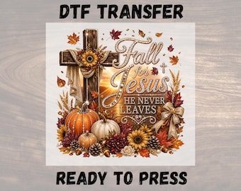 May include: A DTF transfer featuring a wooden cross adorned with a sunflower, draped fabric, and the text Fall for Jesus HE NEVER LEAVES in a jeweled font. Below are pumpkins, sunflowers, autumn leaves, pinecones, and a gold ribbon bow.