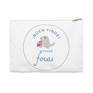 May include: White zippered pouch with a gold-colored zipper pull. The pouch features a circular design with a gray seal holding a pink object, and the text "¡BUEN FINDE! MOTHER focas".