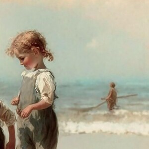 May include: A young girl in a light blue and white dress stands on a sandy beach with the ocean in the background. The girl is looking down at her feet and has her hair pulled back in a ponytail. A blurry figure of a person is in the distance.