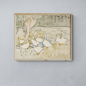 May include: A framed watercolor painting of a group of white geese in a grassy field. The geese are depicted in a loose, gestural style, with their bodies and beaks outlined in black ink. The background is a soft wash of green and brown, suggesting a field or meadow.