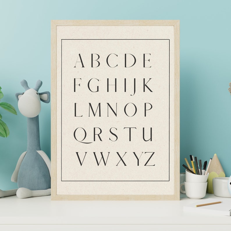 May include: A framed print with a white background and black text. The text is the alphabet in uppercase letters, arranged in rows. The letters are in a simple, modern font.