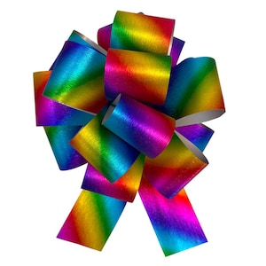 May include: A large, decorative bow made from iridescent rainbow ribbon. The bow has multiple loops and streamers, with a metallic sheen that reflects light. The colours transition smoothly from red to orange, yellow, green, blue, and purple.