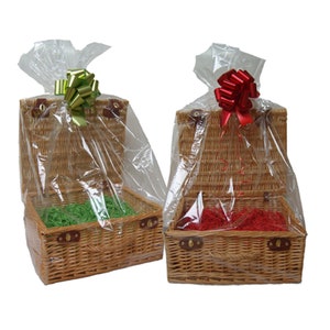 May include: Two wicker gift baskets with lids, one with green tissue paper and a green bow, the other with red tissue paper and a red bow.