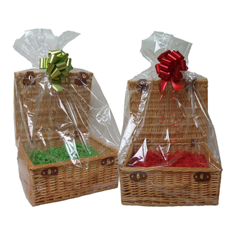 May include: Two wicker gift baskets with lids, one with green tissue paper and a green bow, the other with red tissue paper and a red bow.