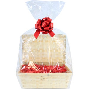 May include: A clear cellophane gift bag with a red bow on top. The bag is over a natural woven bamboo basket filled with red shredded paper.
