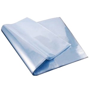 May include: Clear plastic sheets, folded and stacked, for packaging or protecting items.