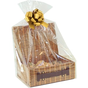 May include: A wicker basket with a brown leather handle is wrapped in clear cellophane and topped with a gold bow. The basket is filled with various items, such as cookies and snacks.