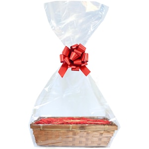 May include: A clear cellophane gift bag with a red bow, containing a brown wicker basket.