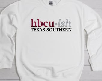 May include: White sweatshirt with the text "hbcu-ish TEXAS SOUTHERN" in maroon, gray, and black. The sweatshirt has a crew neck and long sleeves. The Gildan tag is visible at the back of the neck.