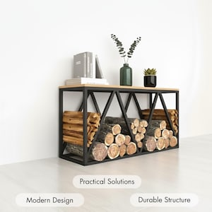 May include: A black metal and wood firewood rack with a light wood top and a geometric design. The rack is filled with cut logs and is decorated with books, a vase, and a potted plant. The text on the image says "Practical Solutions", "Modern Design", and "Durable Structure".