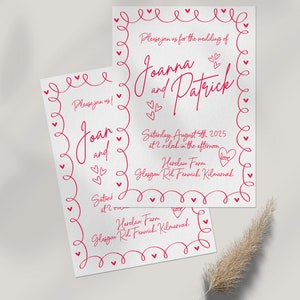 May include: Two white wedding invitations with red text and heart-shaped accents. The invitations read "Joanna and Patrick" and include the date, time, and location of the wedding. A decorative border of hearts surrounds the text.