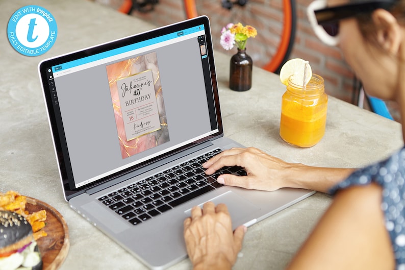 May include: A laptop computer displaying a digital invitation with a marble background and gold accents. The invitation reads "Johannes 40th Birthday".