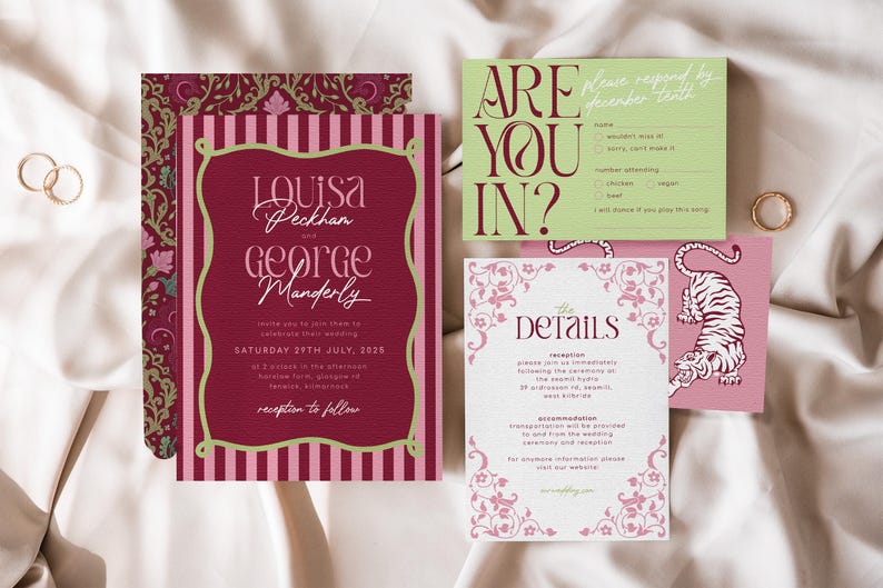 May include: Wedding invitation suite featuring a burgundy and pink color scheme. The main invitation card has the names "Louisa Peckham and George Manderly" in elegant script. Other cards include RSVP and details cards with floral accents and a tiger illustration.