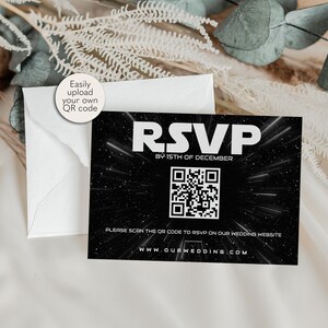 May include: A black and white RSVP card with a Star Wars themed design. The card features a QR code and the text "RSVP by 15th of December" and "Please scan the QR code to RSVP on our wedding website www.ourwedding.com".