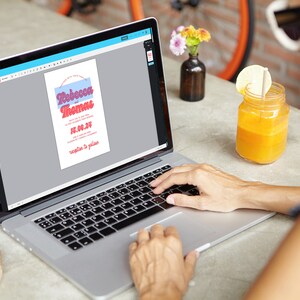 May include: A person is using a laptop to edit a wedding invitation template. The invitation is for Rebecca and Thomas and features a retro font style. The invitation is in a light blue and pink color scheme.