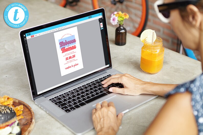 May include: A person is using a laptop to edit a wedding invitation template. The invitation is for Rebecca and Thomas and features a retro font style. The invitation is in a light blue and pink color scheme.