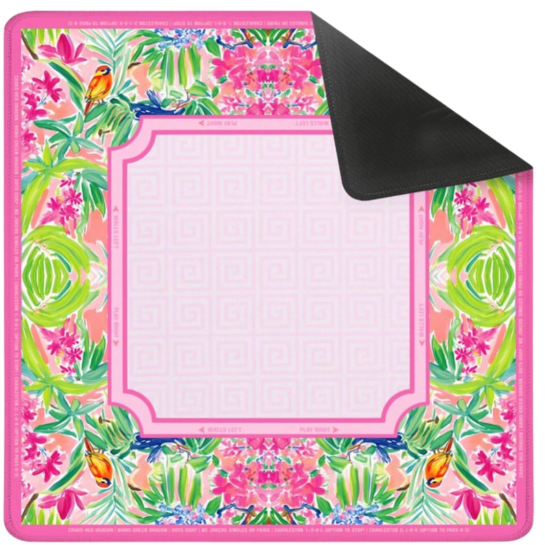 May include: A rectangular pink mousepad with a vibrant floral and bird pattern. The design includes pink flowers, green leaves, and orange birds. The center has a light pink square with a geometric pattern and a decorative border. The back is black.