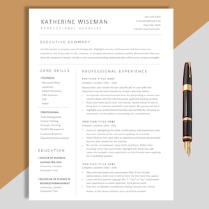 May include: A resume template featuring "Katherine Wiseman" at the top, with sections for core skills, professional experience, and education. A black and gold pen is positioned on the right side of the document.