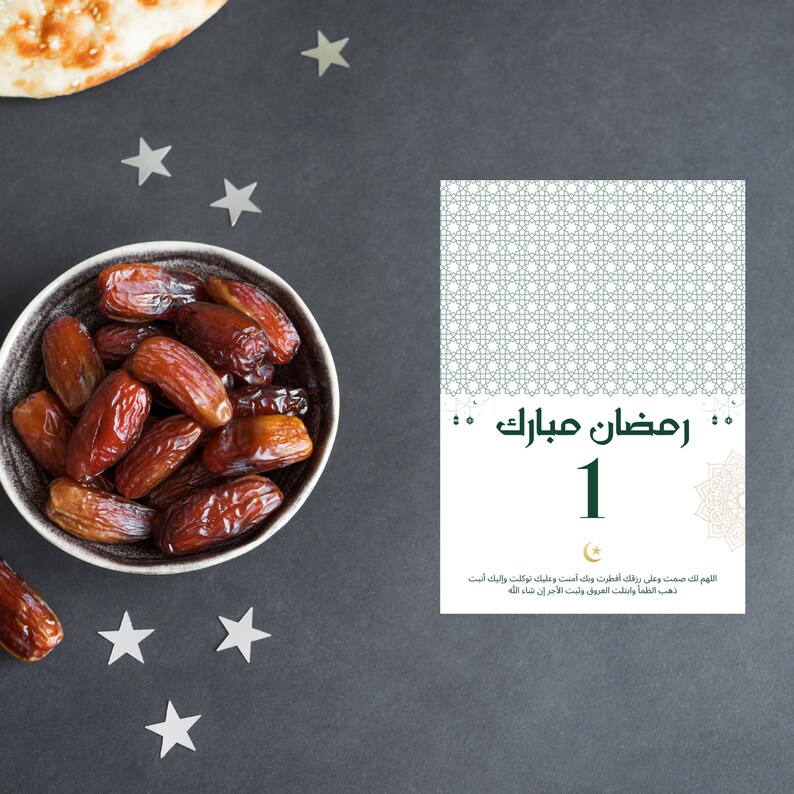 May include: A bowl of dates, a traditional food eaten during Ramadan, with a card that says "Ramadan Mubarak 1" in Arabic. The card also includes a prayer in Arabic.