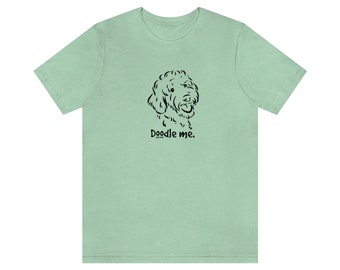 May include: A light green t-shirt with a black doodle of a dog's head and the text "Doodle me."