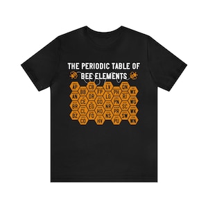 May include: Black t-shirt with a graphic of a periodic table of bee elements. The table is in the shape of a honeycomb and features the text "THE PERIODIC TABLE OF BEE ELEMENTS".