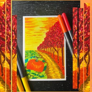 May include: A watercolor painting of a fall landscape featuring a pumpkin in a field, a winding path, and trees with red and orange foliage. The sky is yellow and orange. Two orange markers are on the right side of the painting.