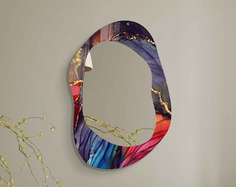May include: A colorful abstract mirror with a unique organic shape. The mirror has a blue, red, purple, and gold design. The mirror is hanging on a light gray wall.