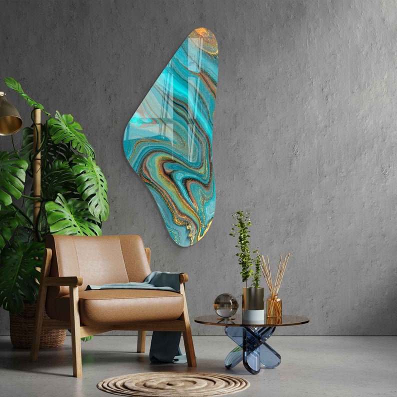 May include: Abstract wall art featuring a blue, gold, and white marbled design in a unique, free-form shape.