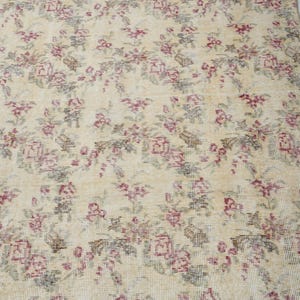 May include: A vintage floral patterned rug with a cream background and pink and green floral designs.
