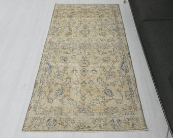 May include: A vintage style rug with a floral pattern in shades of beige and blue. The rug has a distressed look and is perfect for adding a touch of traditional charm to any room.