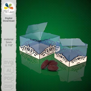 May include: Two clear acrylic boxes with decorative wooden bases. The boxes have hinged lids and are partially open. The wooden bases feature an ornate, swirling design. The boxes are shown with several brown dates.